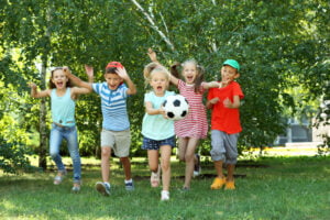 Happy, active children playing with soccer ball